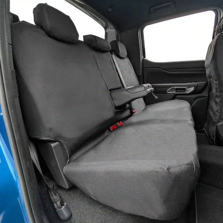 Rear bench seat cover with dark gray fabric, headrest covers, and red latch points