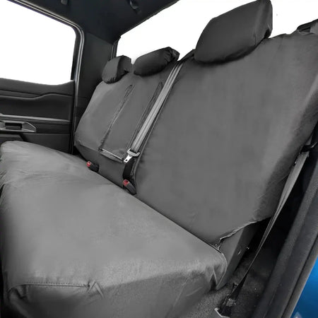 Rear seat back cover in dark gray with vertical seams and seatbelt strap cutouts