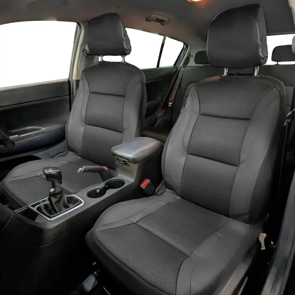 Installed front seat covers in a car, gray textured upholstery with dark trim edges