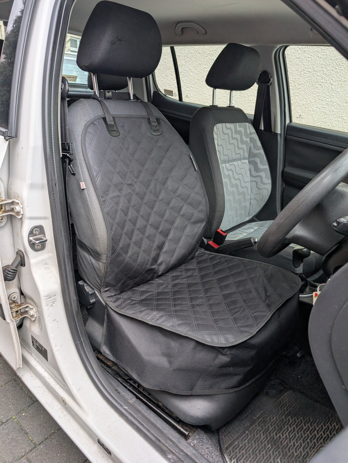 Installed front seat protector set with quilted cover and matching dark gray side panels