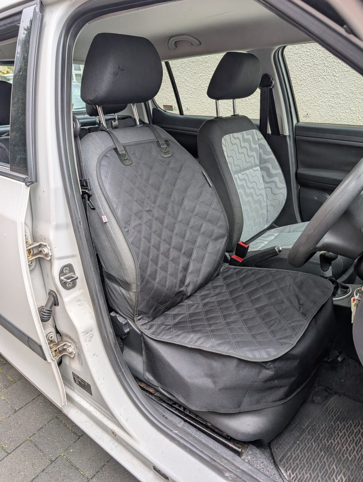 Installed single seat protector with quilted seat and backrest cover in dark gray