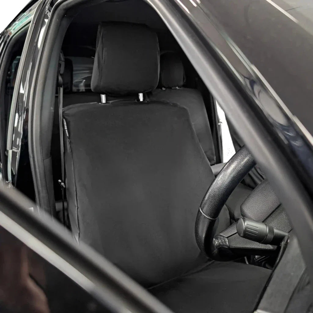 Front seat cover set: black full-seat cover with headrest, viewed from open door