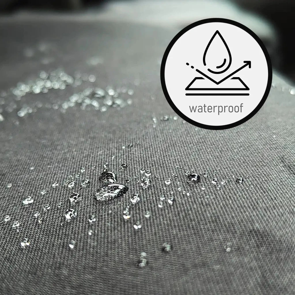 Waterproof dark fabric seat cover with water droplets beading on surface